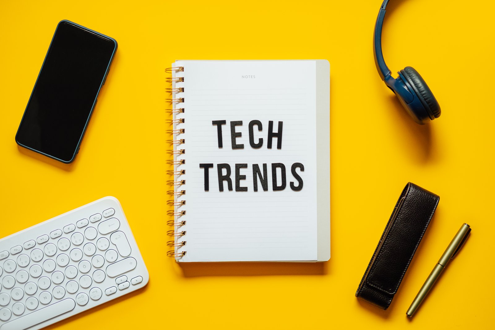 Tech trends, Top New Technology Trends. Word trends on open notepad with different gadgets and
